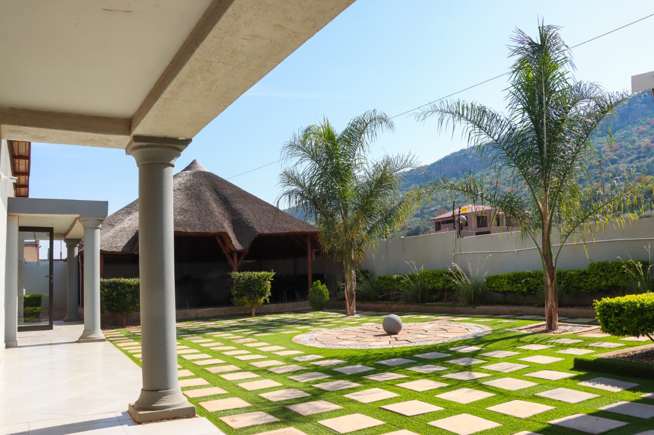 Landscaped garden with thatched gazebo