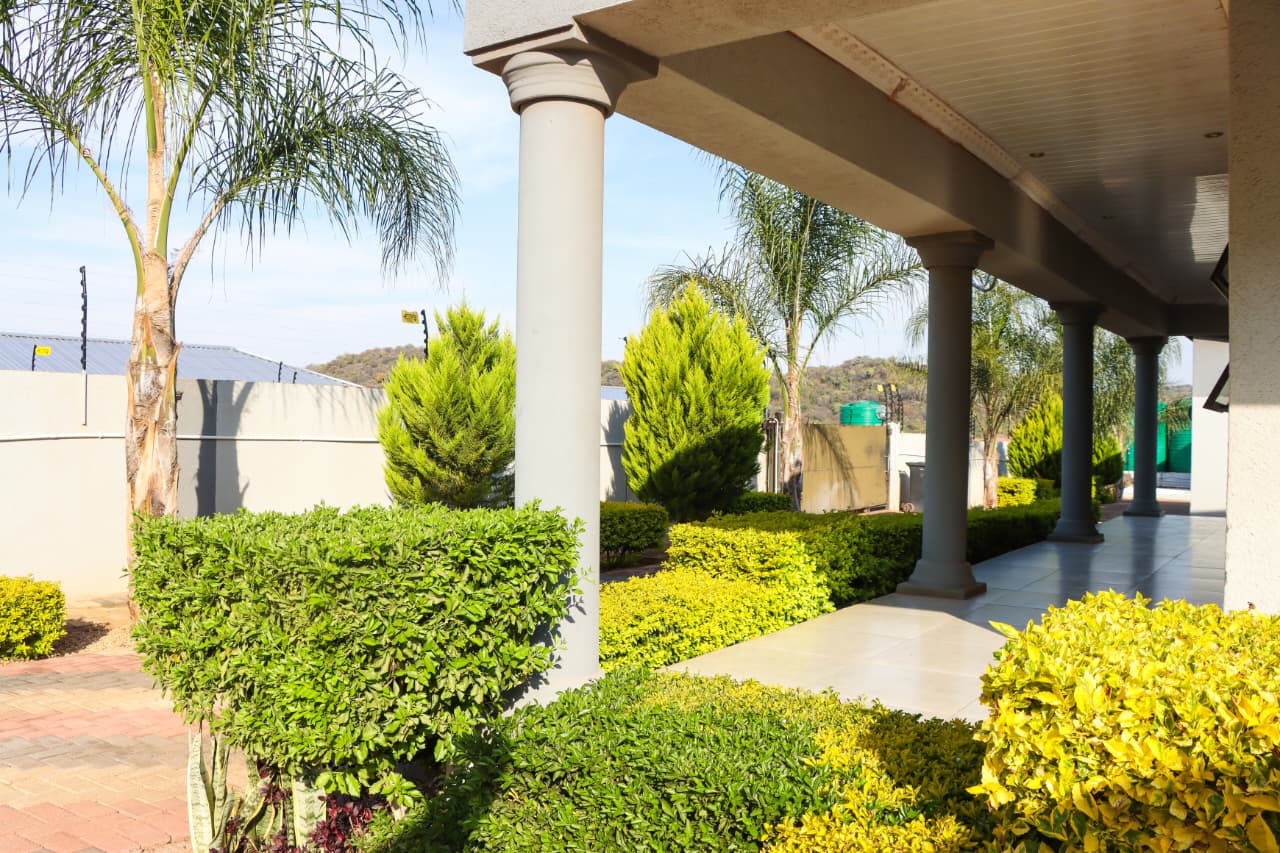Covered garden walkway with columns
